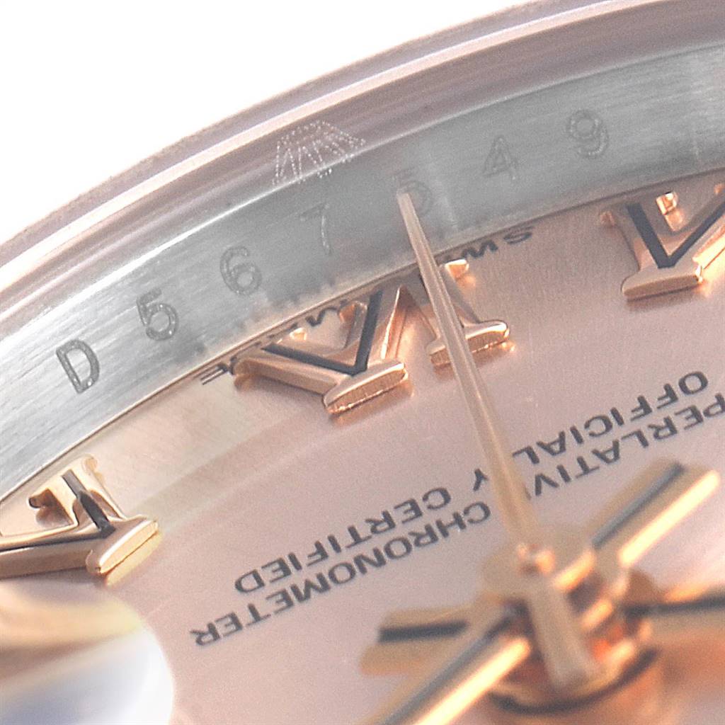 The image shows a close-up angle of the Rolex Datejust 179171 Women's Steel and Gold (two tone) Pink Dial 179171 Women's Steel and Gold (two tone) Pink Dial watch, focusing on the serial number, part of the dial, and Roman numeral markers.