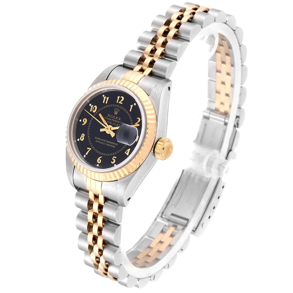 The image shows a Rolex Datejust 69173 Women's Stainless Steel Black Dial 69173 Women's Stainless Steel Black Dial watch from a side angle, highlighting its black dial, gold bezel, and two-tone metal bracelet.