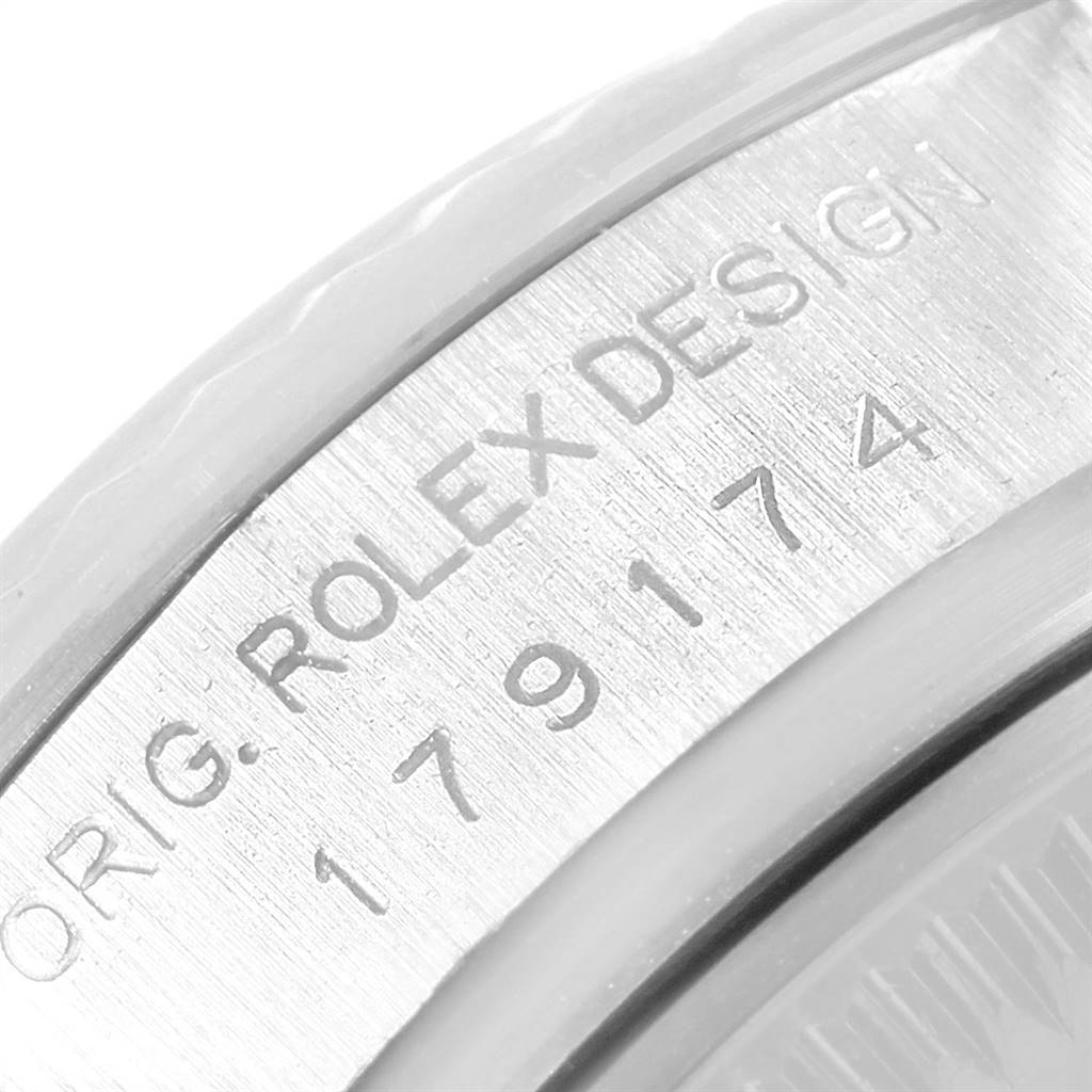 This image shows a close-up of the engraved serial and model number of a Rolex Datejust 179174 Women's Stainless Steel White Dial 179174 Women's Stainless Steel White Dial watch.