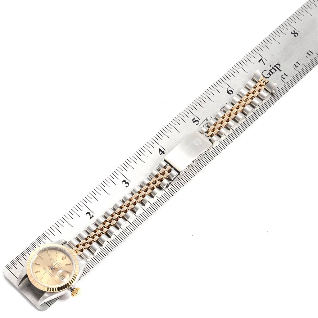 This image shows the Rolex Datejust 69173 Women's Stainless Steel Champagne Dial 69173 Women's Stainless Steel Champagne Dial watch laid flat with its face and bracelet clearly displayed next to a ruler for measurement.