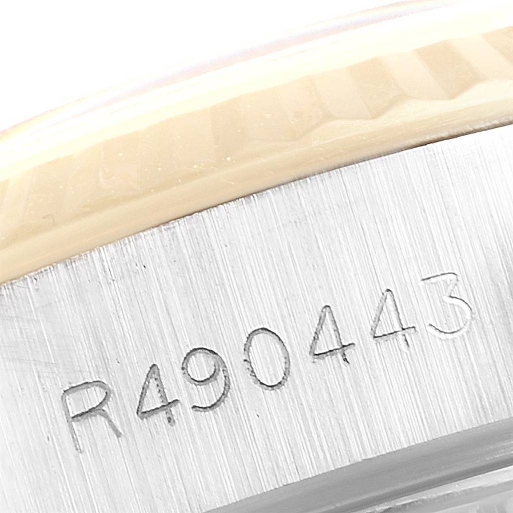 The image shows a close-up of the serial number inscribed on the case of a Rolex Datejust 69173 Women's Stainless Steel Champagne Dial 69173 Women's Stainless Steel Champagne Dial watch.
