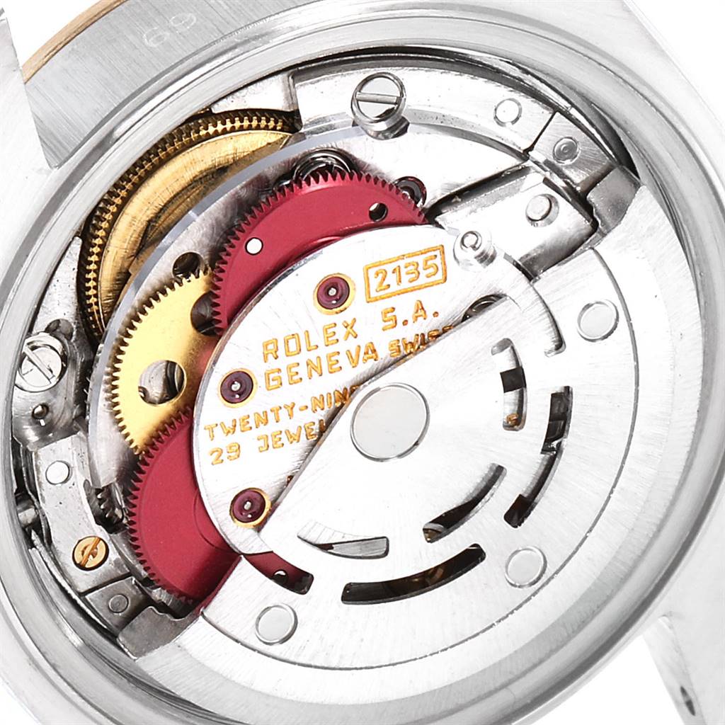 The image shows a close-up of the internal mechanism of a Rolex Datejust 69173 Women's Stainless Steel Champagne Dial 69173 Women's Stainless Steel Champagne Dial watch, highlighting the intricate gears and markings.