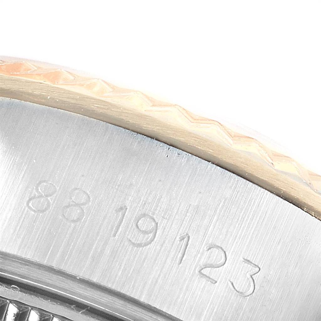 The image shows a close-up of the engraved serial number and part of the bezel of a Rolex Datejust 69173 Women's Stainless Steel White Dial 69173 Women's Stainless Steel White Dial watch.