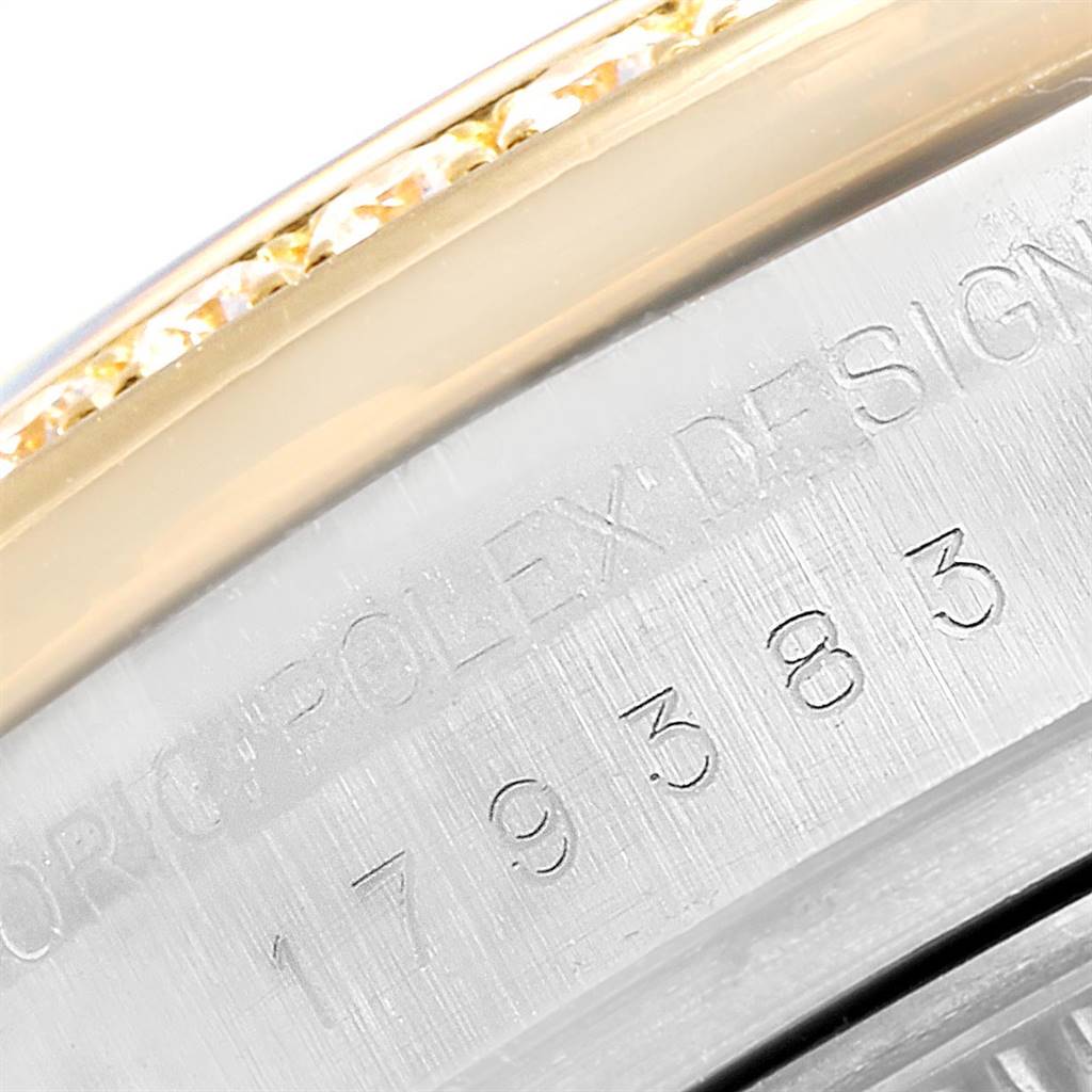 This image shows a close-up of the engraved serial number on the bezel of a Rolex Datejust 179383 Women's Steel and Gold (two tone) White Dial 179383 Women's Steel and Gold (two tone) White Dial watch.