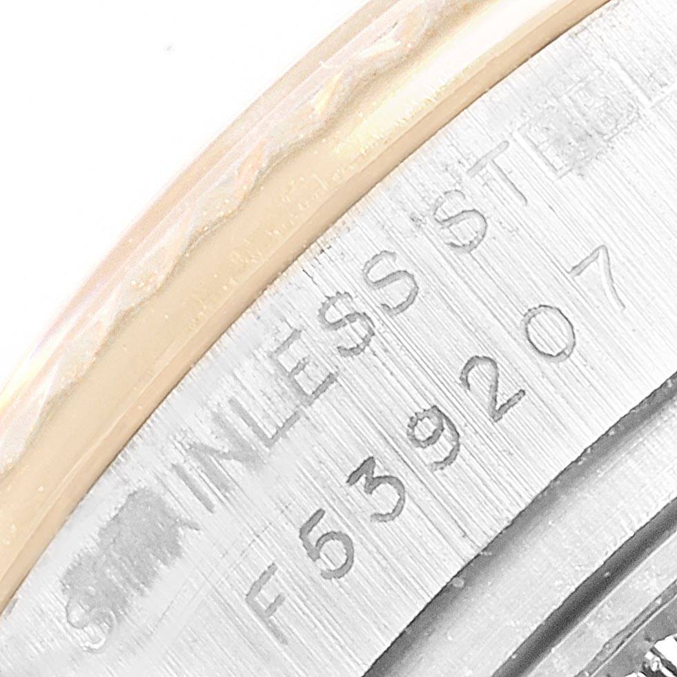 The image shows a close-up of the case back of the Rolex Datejust 179173 Women's Steel and Gold (two tone) Blue Dial 179173 Women's Steel and Gold (two tone) Blue Dial, focusing on the serial and material engraving.