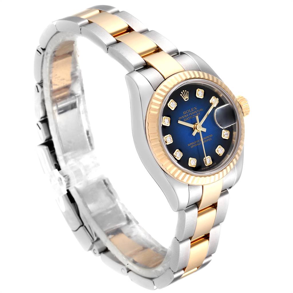 The image shows a Rolex Datejust 179173 Women's Steel and Gold (two tone) Blue Dial 179173 Women's Steel and Gold (two tone) Blue Dial watch at a three-quarter angle, highlighting its face, bezel, crown, and two-tone bracelet.