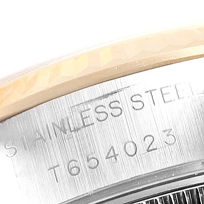This image shows a close-up of the case back engraving on a Rolex Datejust 69173 Women's Stainless Steel Beige Dial 69173 Women's Stainless Steel Beige Dial model, displaying serial numbers and "STAINLESS STEEL."
