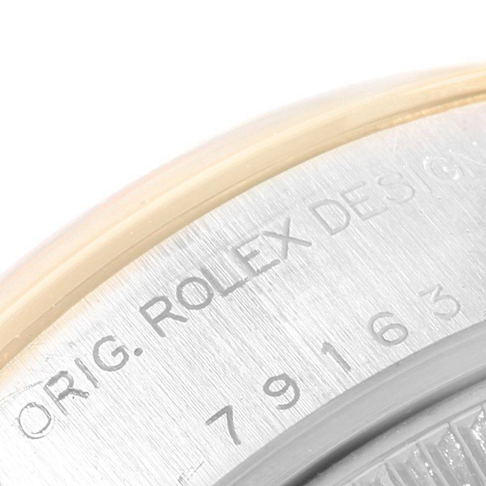 This image shows a close-up of the case back of a Rolex Datejust 79163 Women's Steel and Gold (two tone) Silver Dial 79163 Women's Steel and Gold (two tone) Silver Dial watch, highlighting the engraved serial numbers and lettering.