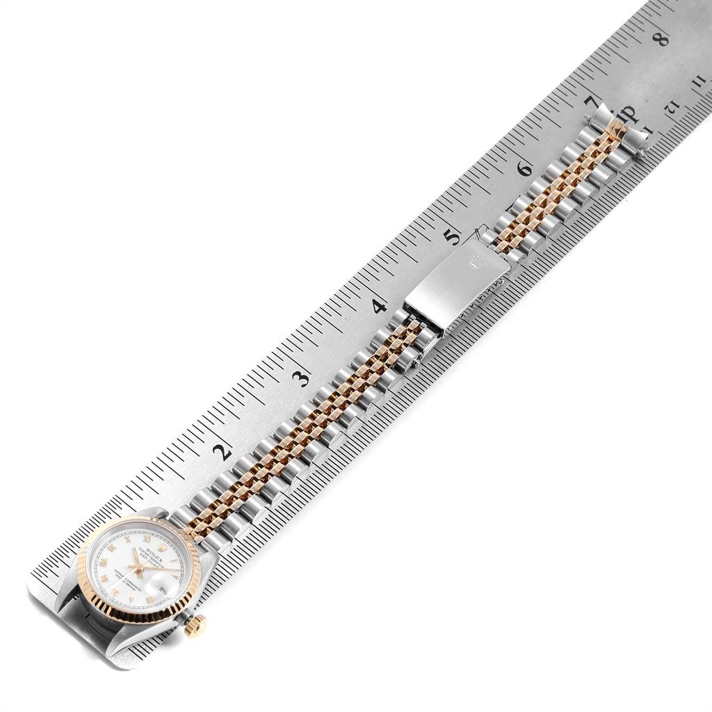 The image shows a Rolex Datejust 69173 Women's Stainless Steel White Dial 69173 Women's Stainless Steel White Dial watch laid flat on a ruler, emphasizing its bracelet and clasp.