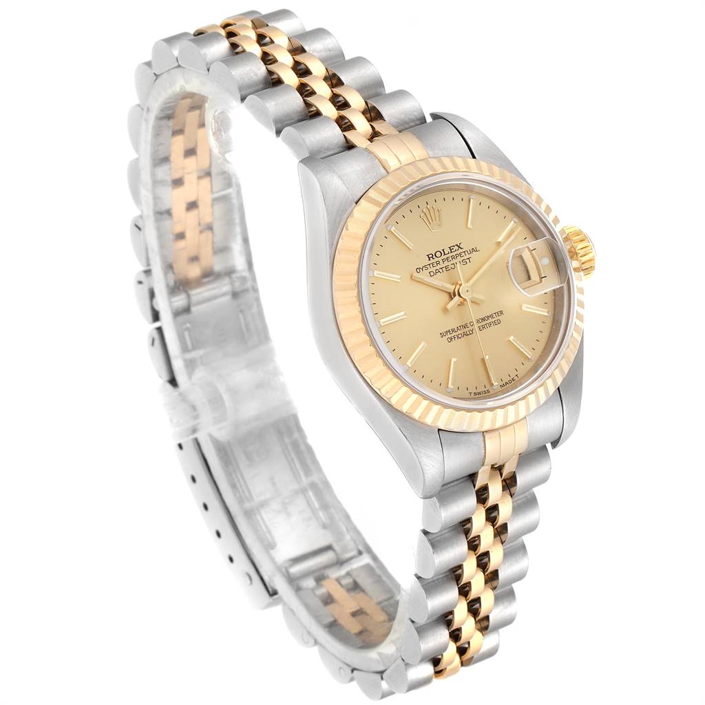 The image shows a Rolex Datejust 79173 Women
s Steel and Gold (two tone) Champagne Dial 79173 Women
s Steel and Gold (two tone) Champagne Dial watch at an angle emphasizing the gold and silver two-tone bracelet, bezel, and champagne dial.