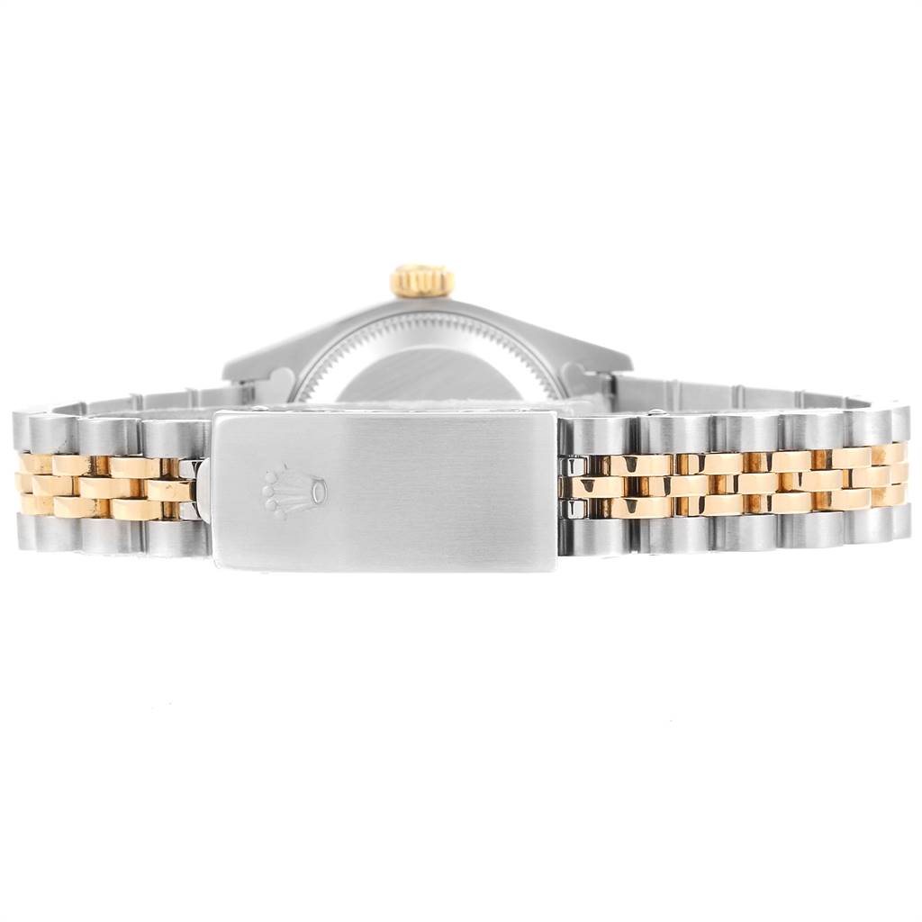The image shows the back view of a Rolex Datejust 79173 Women
s Steel and Gold (two tone) Champagne Dial 79173 Women
s Steel and Gold (two tone) Champagne Dial watch, highlighting its bicolored metal bracelet and clasp.