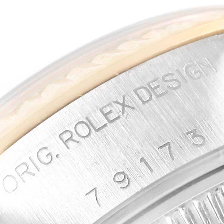 This close-up image shows the engraved bezel and part of the case of a Rolex Datejust 79173 Women
s Steel and Gold (two tone) Champagne Dial 79173 Women
s Steel and Gold (two tone) Champagne Dial watch.