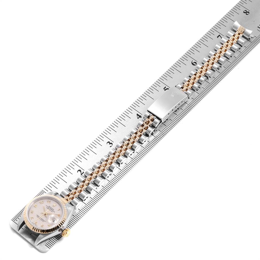 This image shows a Rolex Datejust 69173 Women's Stainless Steel Beige Dial 69173 Women's Stainless Steel Beige Dial watch laid out flat alongside a measuring ruler, displaying its full length and bracelet.