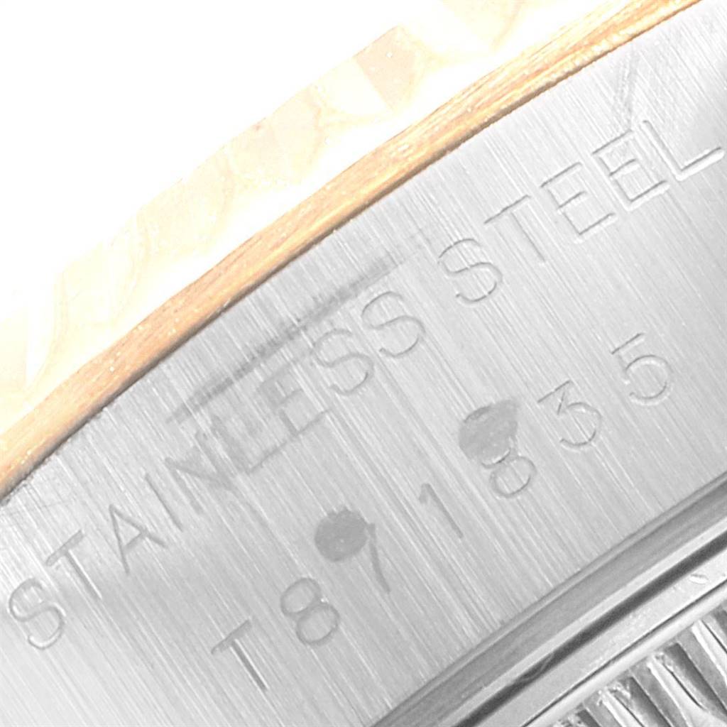 The image shows a close-up of the side of a Rolex Datejust 69173 Women's Stainless Steel Beige Dial 69173 Women's Stainless Steel Beige Dial watch, highlighting the "STAINLESS STEEL" engraving.
