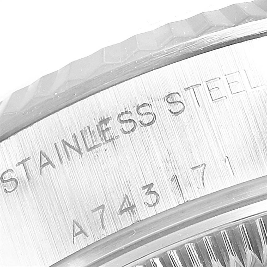 The image shows a close-up of the side of a Rolex Datejust 79174 Women's Stainless Steel White Dial 79174 Women's Stainless Steel White Dial watch, highlighting the stainless steel marking and part of the bezel.