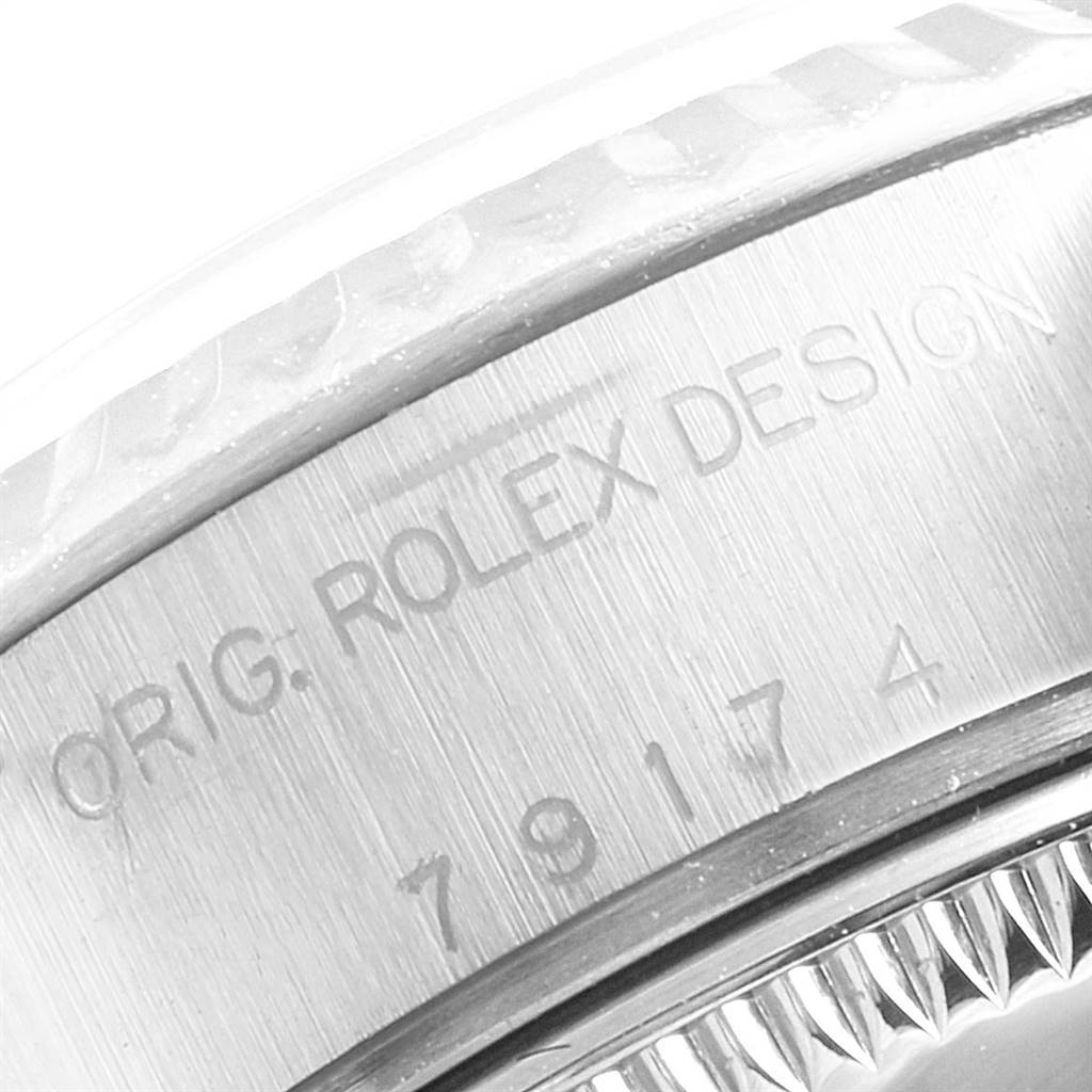 This image shows the engraved caseback area of a Rolex Datejust 79174 Women
s Stainless Steel White Dial 79174 Women
s Stainless Steel White Dial watch, highlighting the model and serial numbers.