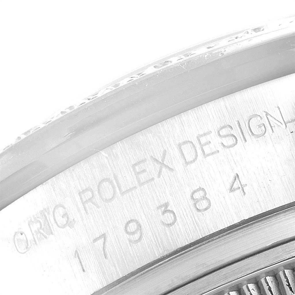 This image shows a close-up of the engraved casing edge of a Rolex Datejust 179384 Women's Stainless Steel Mother of Pearl Dial 179384 Women's Stainless Steel Mother of Pearl Dial model.