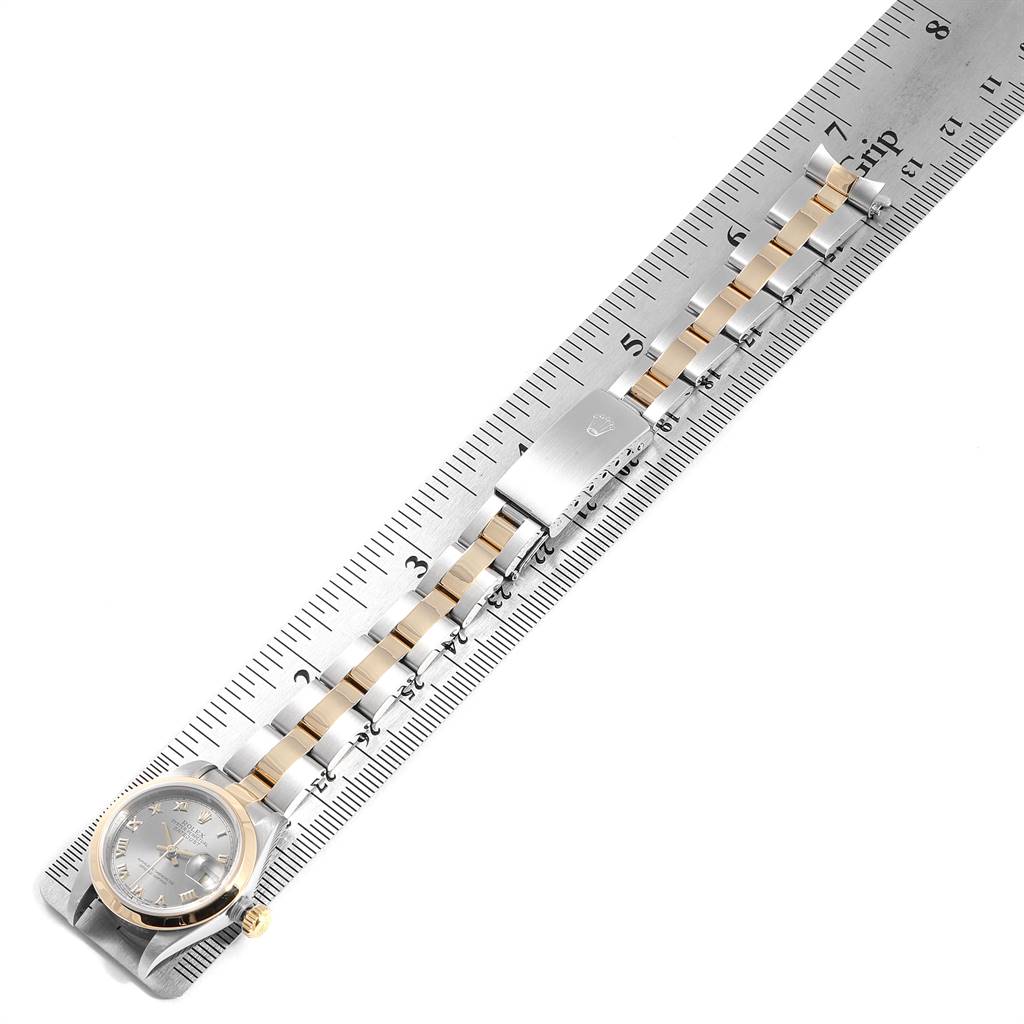 The Rolex Datejust 69163 Women's Stainless Steel Grey Dial 69163 Women's Stainless Steel Grey Dial watch is shown laid flat on a ruler, displaying the face, bezel, and bracelet.