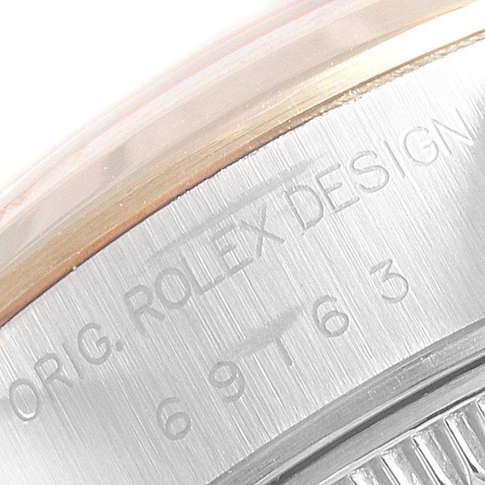 This is a close-up view of the back casing of a Rolex Datejust 69163 Women's Stainless Steel Grey Dial 69163 Women's Stainless Steel Grey Dial watch, showing the engraved text and serial number.