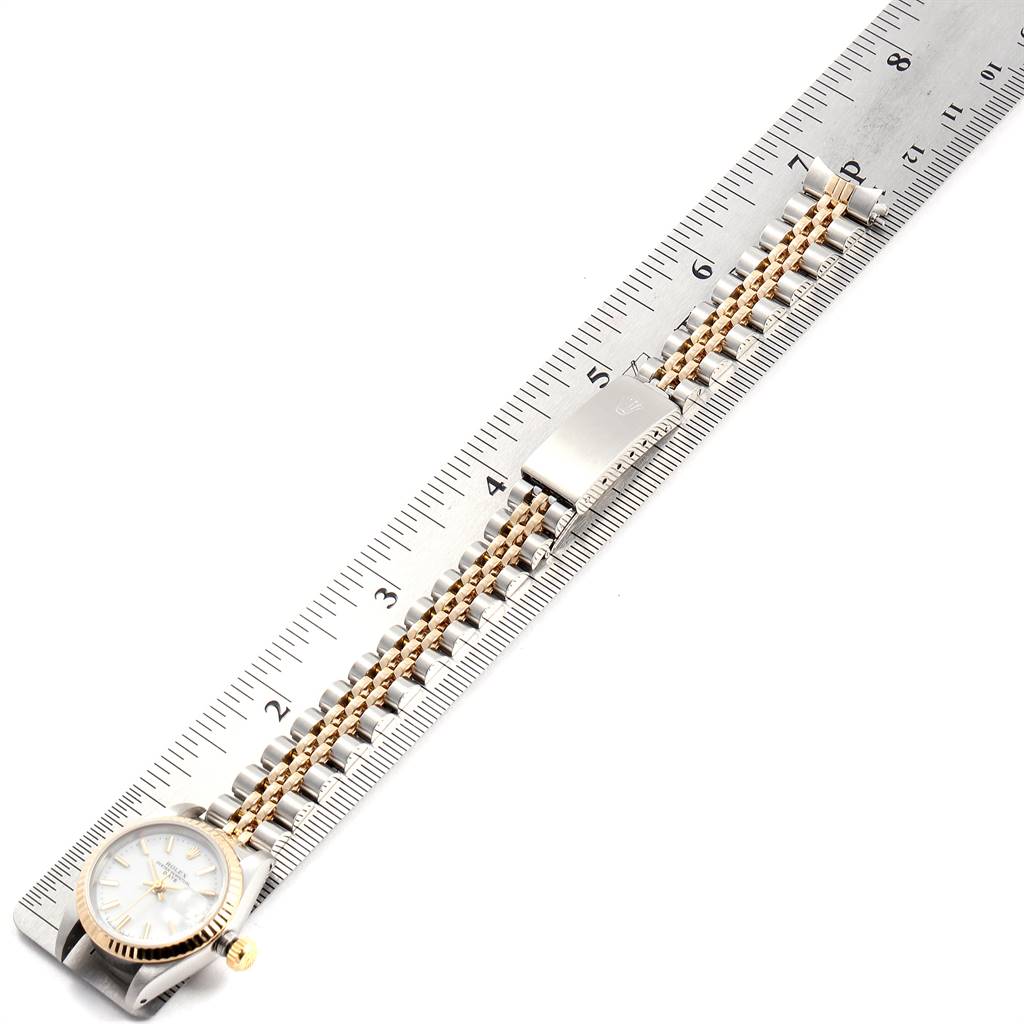 The Rolex Datejust 69173 Women's Stainless Steel White Dial 69173 Women's Stainless Steel White Dial watch is shown from a top view alongside a ruler, displaying the dial and the metal bracelet.