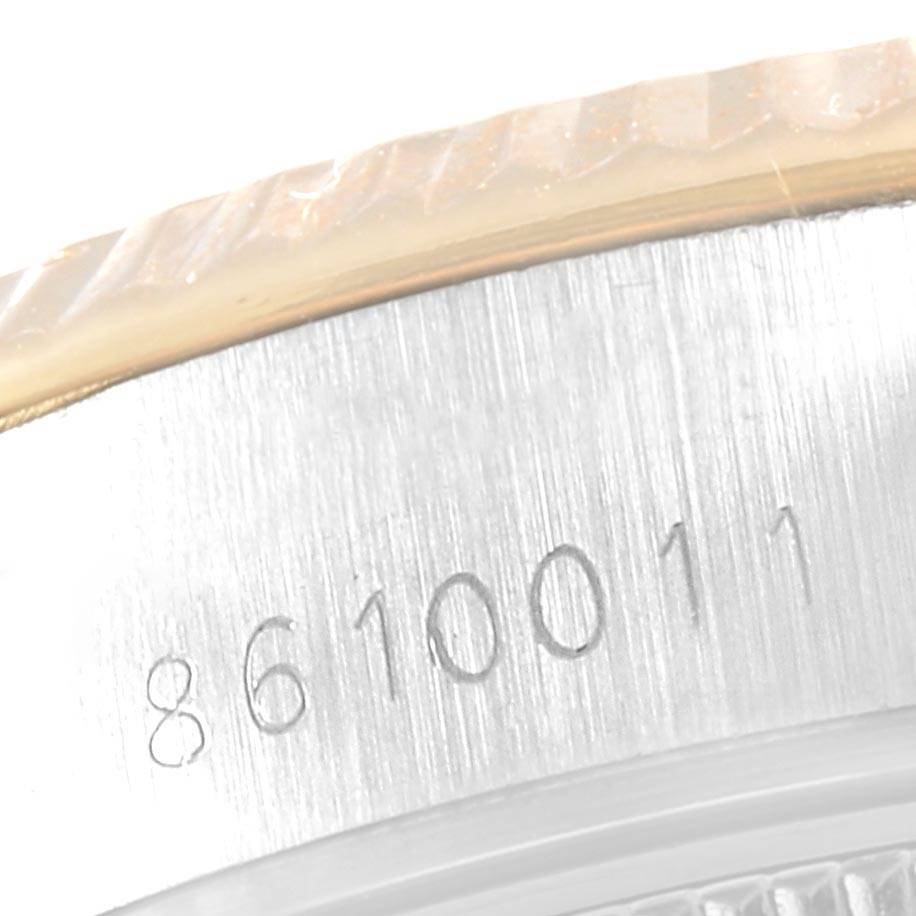 This image shows a close-up view of the serial number and part of the bezel on a Rolex Datejust 69173 Women's Stainless Steel White Dial 69173 Women's Stainless Steel White Dial watch.