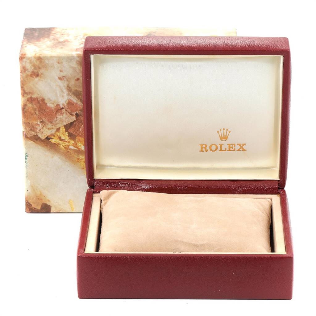 The image shows an open Rolex watch box for the Datejust model, revealing a beige cushion inside.