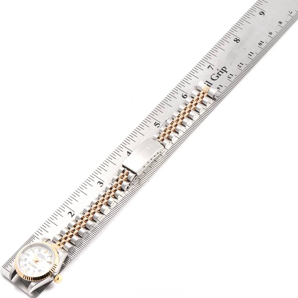 The image shows a Rolex Datejust 69173 Women's Steel and Gold (two tone) White Dial 69173 Women's Steel and Gold (two tone) White Dial watch laid flat alongside a ruler, displaying the watch face and band.