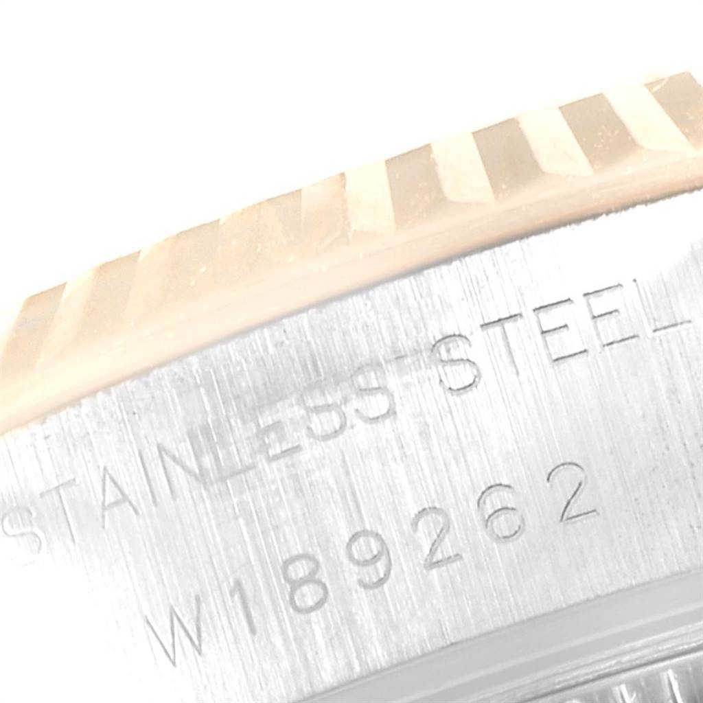 This image shows a close-up of the side of a Rolex Datejust 69173 Women's Steel and Gold (two tone) White Dial 69173 Women's Steel and Gold (two tone) White Dial watch, highlighting the fluted bezel and engraved text on the steel case.