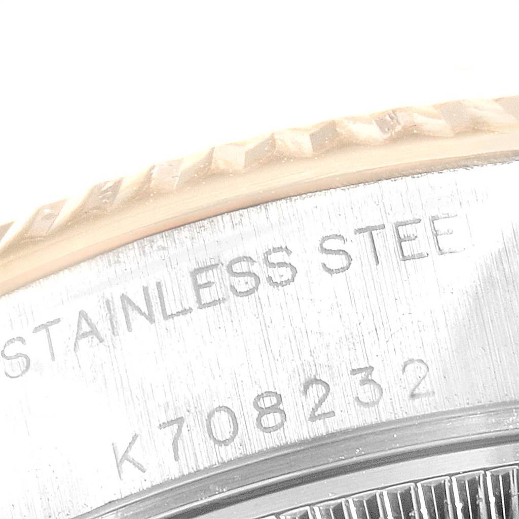 This image shows a close-up of the case back and fluted bezel on a Rolex Datejust 79173 Women
s Steel and Gold (two tone) Grey Dial 79173 Women
s Steel and Gold (two tone) Grey Dial watch, displaying the serial number and "STAINLESS STEEL" engraving.