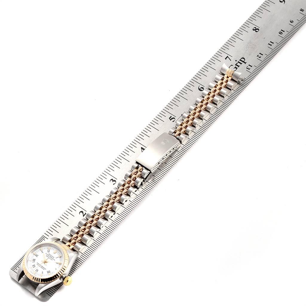 This image shows a Rolex Datejust 69173 Women's Steel and Gold (two tone) White Dial 69173 Women's Steel and Gold (two tone) White Dial watch positioned alongside a ruler, highlighting the watch's bracelet and clasp.