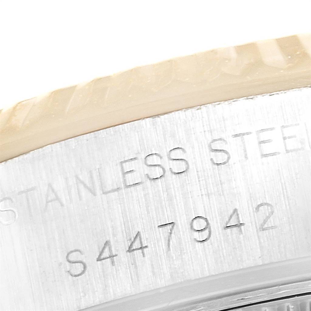 The image shows a close-up of the engraved serial number and "STAINLESS STEEL" on the side of a Rolex Datejust 69173 Women's Steel and Gold (two tone) White Dial 69173 Women's Steel and Gold (two tone) White Dial watch case.