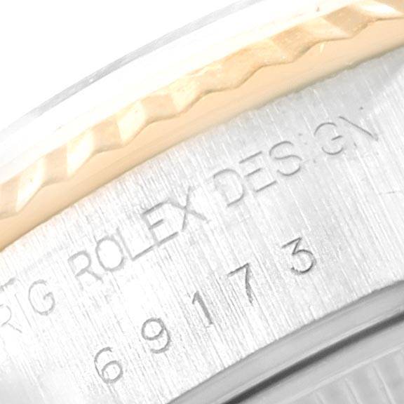 Close-up of the Rolex Datejust 69173 Women's Steel and Gold (two tone) White Dial 69173 Women's Steel and Gold (two tone) White Dial model bezel and engraved text on the case.