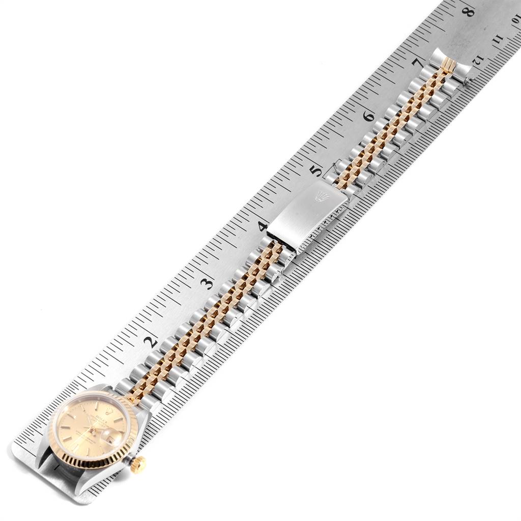 The image shows the Rolex Datejust 69173 Women's Stainless Steel Champagne Dial 69173 Women's Stainless Steel Champagne Dial watch laid flat against a ruler, highlighting the bracelet and case from a top-down angle.