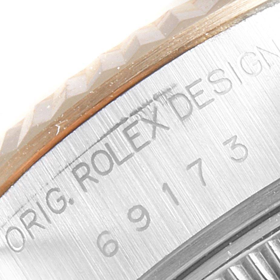 This image shows a close-up of the Rolex Datejust 69173 Women's Stainless Steel Champagne Dial 69173 Women's Stainless Steel Champagne Dial's bezel and serial number engraving.