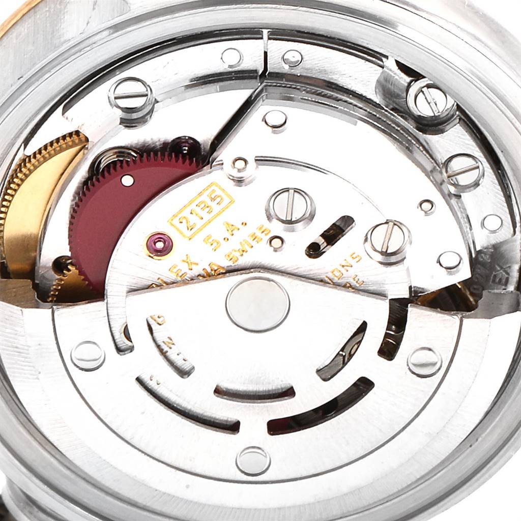 The image shows a close-up view of the movement mechanism of a Rolex Datejust 69173 Women's Steel and Gold (two tone) White Dial 69173 Women's Steel and Gold (two tone) White Dial watch, including gears and the rotor.