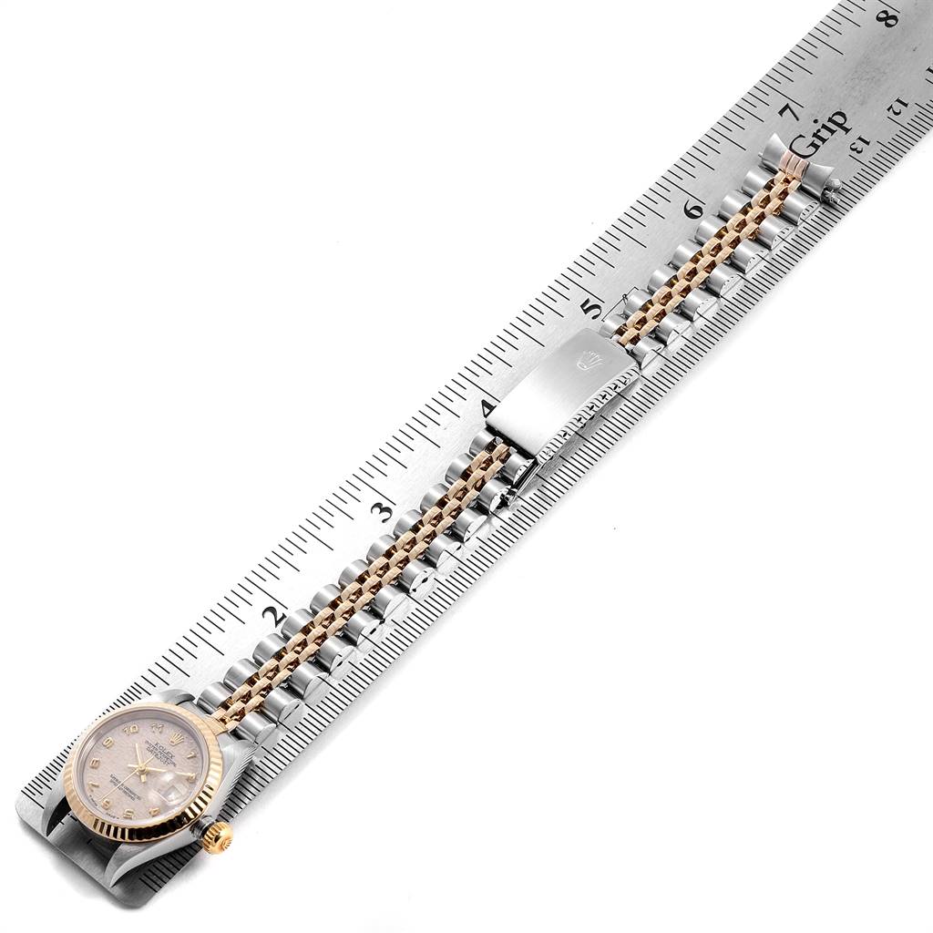 The image shows a Rolex Datejust 69173 Women's Stainless Steel Beige Dial 69173 Women's Stainless Steel Beige Dial watch and its metal bracelet laid flat next to a ruler from a top-down angle.