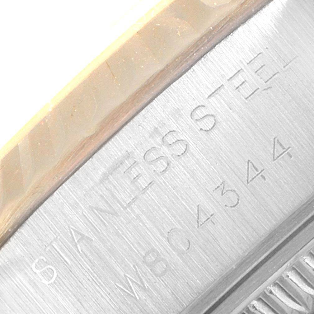 The image shows a close-up of the side engraving of a Rolex Datejust 69173 Women's Stainless Steel Beige Dial 69173 Women's Stainless Steel Beige Dial watch, focusing on the text "STAINLESS STEEL" and a serial number.