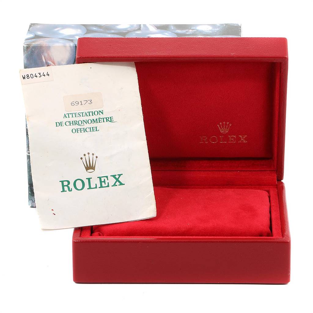 The image shows a red Rolex Datejust 69173 Women's Stainless Steel Beige Dial 69173 Women's Stainless Steel Beige Dial watch box with an official Rolex certificate booklet placed in front of it.