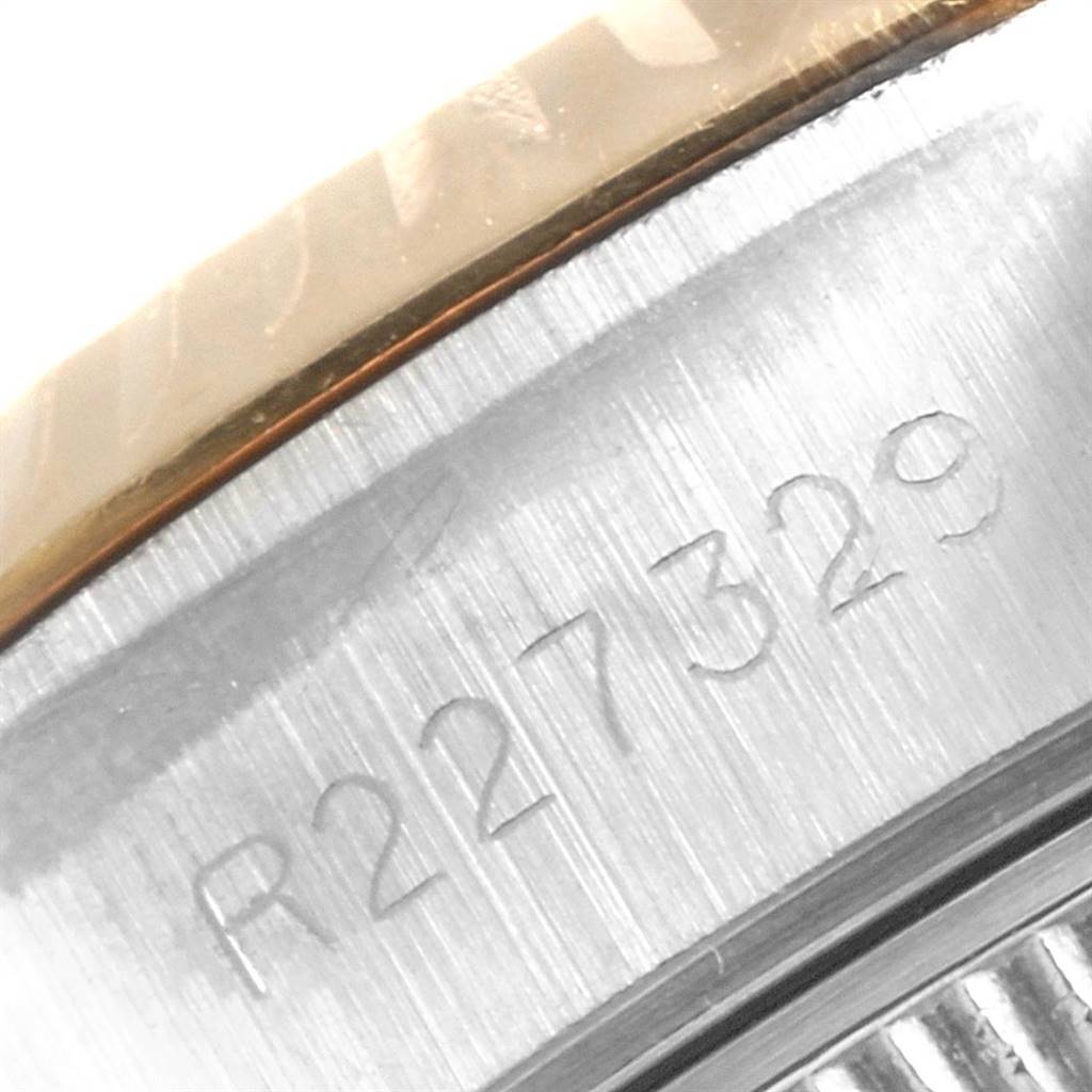 The image shows a close-up of the side of a Rolex Datejust 69173 Women's Stainless Steel Champagne Dial 69173 Women's Stainless Steel Champagne Dial watch, focusing on its engraved serial number.