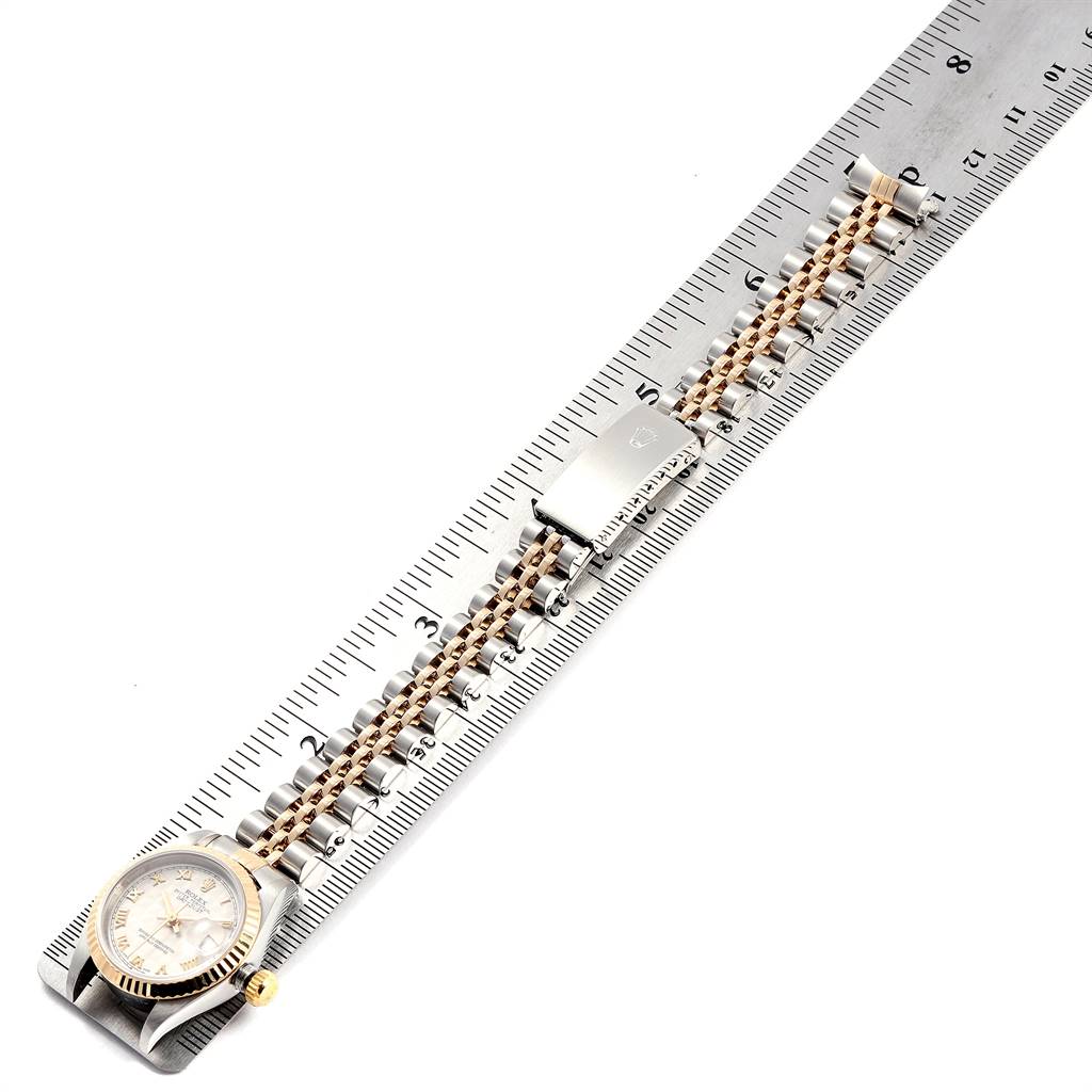 The Rolex Datejust 69173 Women's Stainless Steel Beige Dial 69173 Women's Stainless Steel Beige Dial watch is shown flat on a ruler, displaying its dial, bezel, bracelet, and clasp.