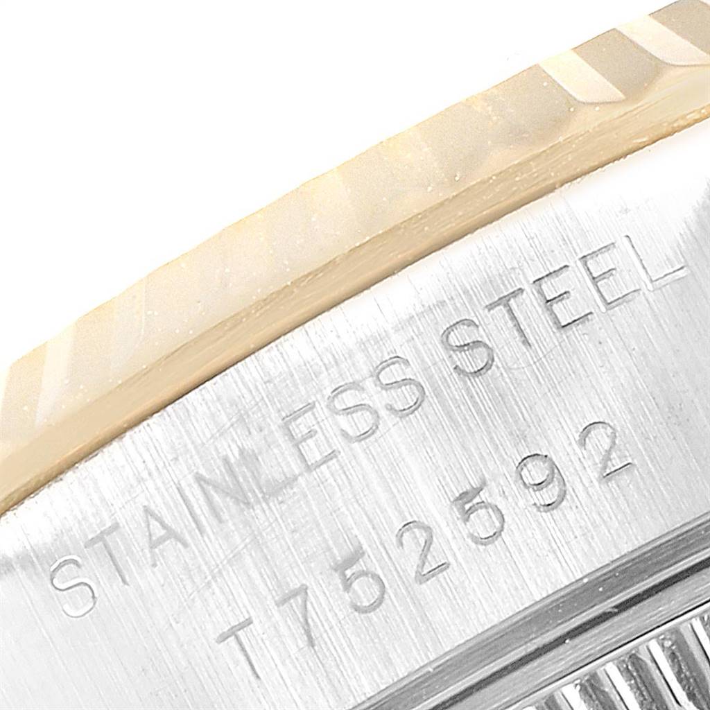 This image shows a close-up of the side engraving and part of the fluted bezel of a Rolex Datejust 69173 Women's Stainless Steel Beige Dial 69173 Women's Stainless Steel Beige Dial watch.