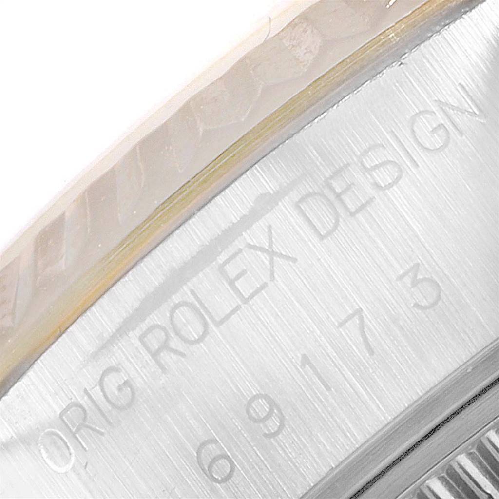 This image shows a close-up of the side view of the casing of a Rolex Datejust 69173 Women's Steel and Gold (two tone) Champagne Dial 69173 Women's Steel and Gold (two tone) Champagne Dial watch, highlighting the engraved text "ORIG ROLEX DESIGN."
