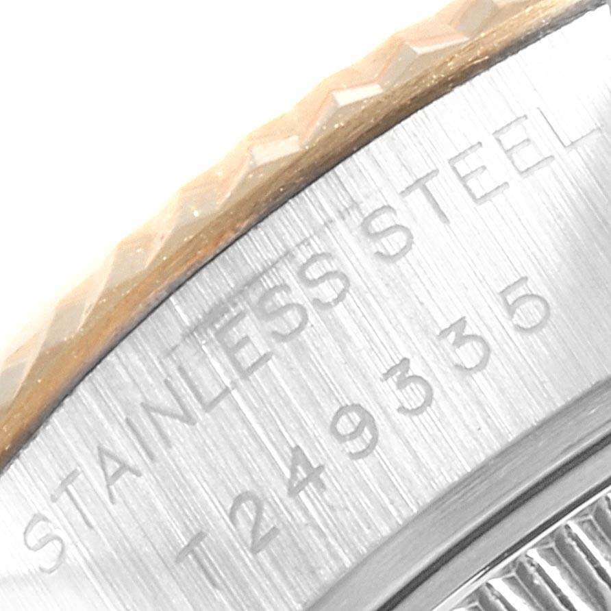 This image shows a close-up of the engraved text on the case of a Rolex Datejust 69173 Women's Stainless Steel Silver Dial 69173 Women's Stainless Steel Silver Dial watch along with part of its fluted bezel.