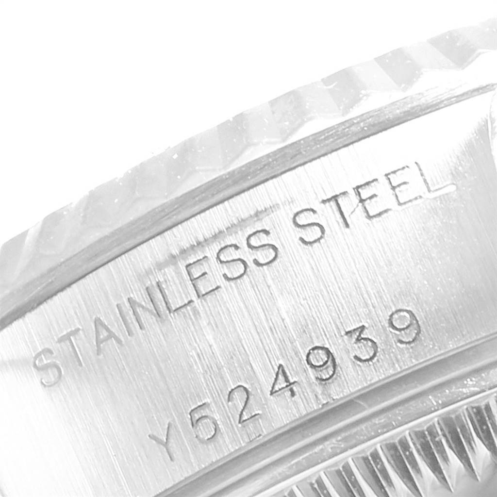 The image shows a close-up of the serial number and "STAINLESS STEEL" engraving on the bezel edge of a Rolex Datejust 79174 Women's Stainless Steel Black Dial 79174 Women's Stainless Steel Black Dial watch.