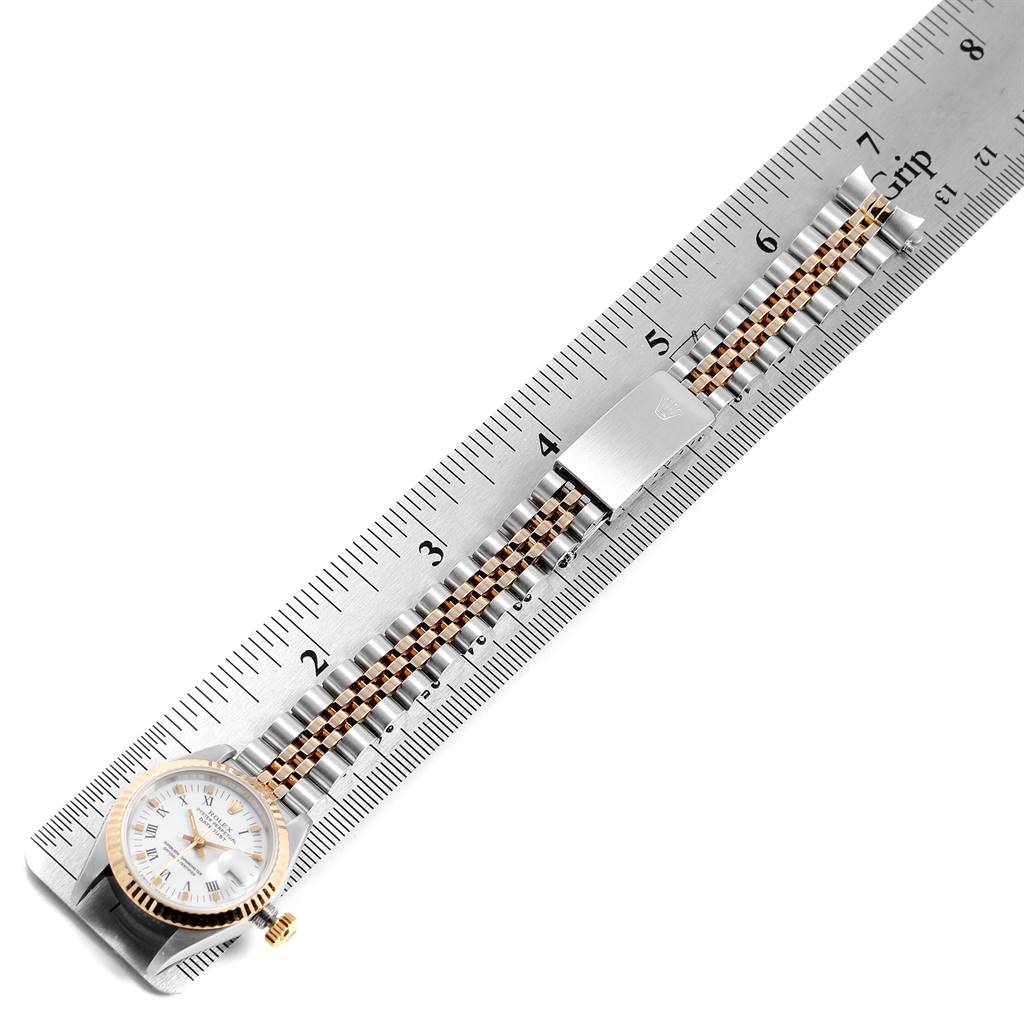 This image shows a top view of a Rolex Datejust 69173 Women's Stainless Steel White Dial 69173 Women's Stainless Steel White Dial watch with its bracelet aligned alongside a ruler for measurement.