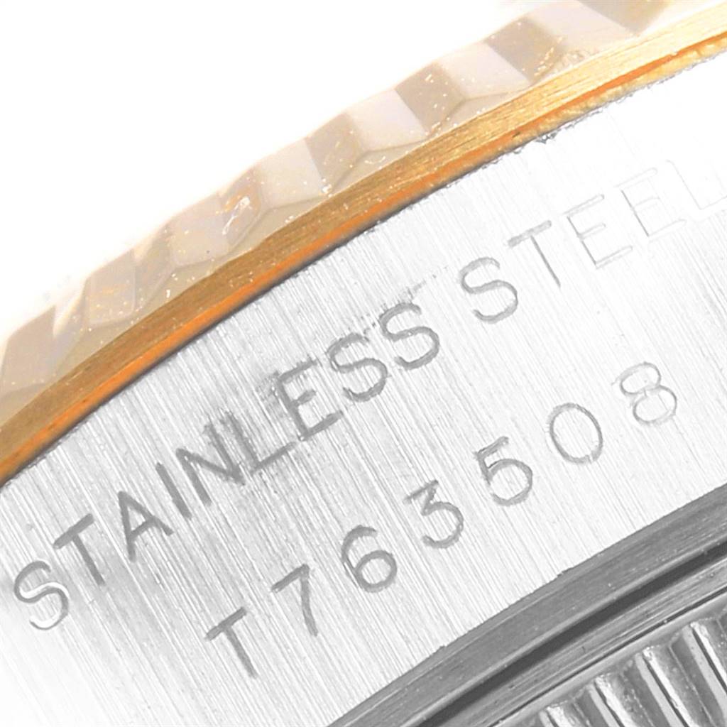 The image shows a close-up view of the serial number and "STAINLESS STEEL" engraving on the case edge of a Rolex Datejust 69173 Women's Stainless Steel White Dial 69173 Women's Stainless Steel White Dial model.