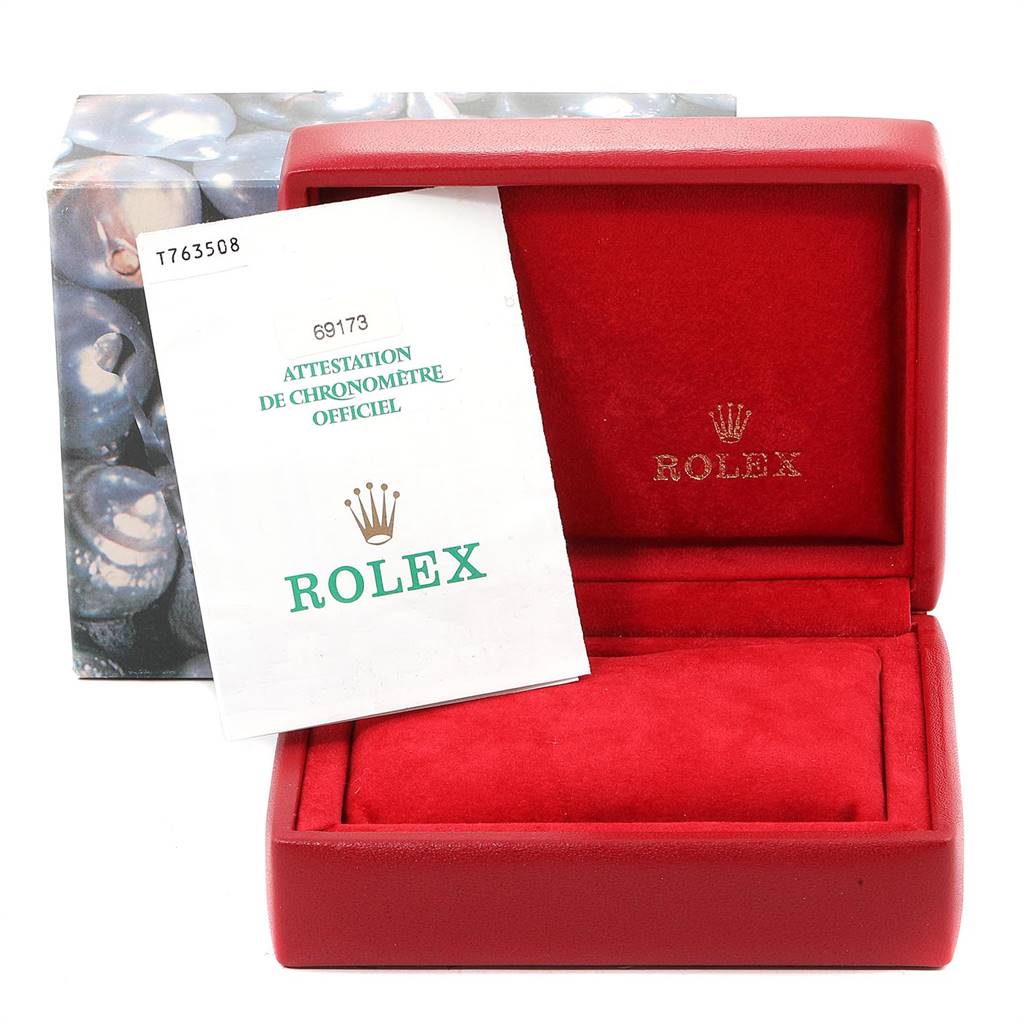 The image shows a Rolex Datejust 69173 Women's Stainless Steel White Dial 69173 Women's Stainless Steel White Dial watch’s red case and official chronometer certificate at a front angle.