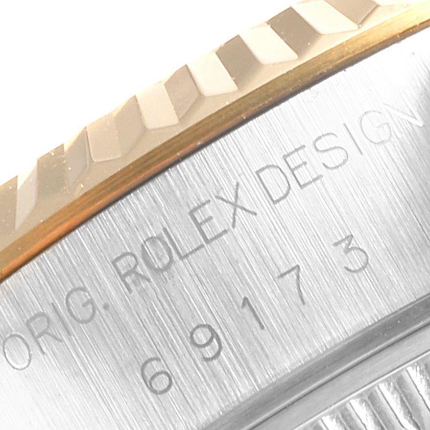The image shows a close-up view of the case side and fluted bezel of a Rolex Datejust 69173 Women's Stainless Steel White Dial 69173 Women's Stainless Steel White Dial watch, highlighting the engraved text.