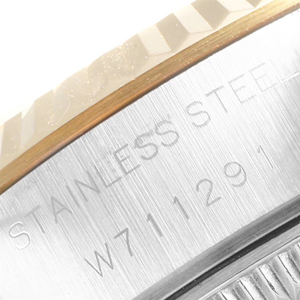 This image shows a close-up of the stainless steel case and fluted bezel of a Rolex Datejust 69173 Women's Stainless Steel White Dial 69173 Women's Stainless Steel White Dial watch.