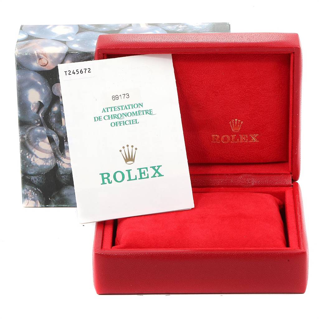 This image shows a Rolex Datejust 69173 Women
s Stainless Steel Silver Dial 69173 Women
s Stainless Steel Silver Dial watch box and official certification booklet, with the box open to reveal its red interior.